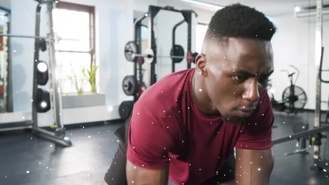 Male trainee starting set lifting dumbbell bracing bench training for fitness particles floating