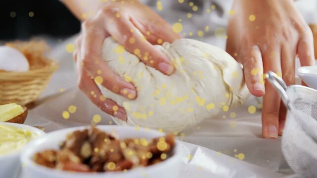 Baker placing hands on dough, kneading and shaping with yellow overlay, preparing for baking