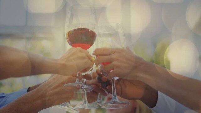 Woman calling toast, friends raising glasses on patio celebrating event, bokeh overlaying glasses