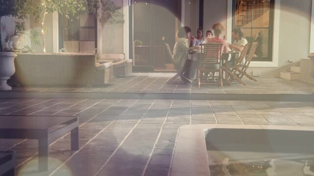 Camera pulling in and bokeh softening, friends cheering and sharing food in poolside lifestyle