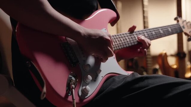 close up man playing guitar