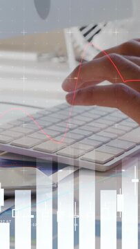 Vertical video: Right hand pressing keyboard, hands typing, charts aligning over keys for finance