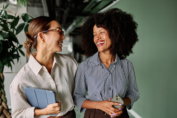 Portrait of two young business woman having a meeting or presentation and seminar standing in the...