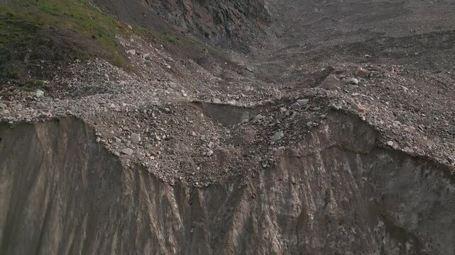 Aerial close up Shkhara Glacier base by Mount Shkhara. Massive ice flow, rocky moraine near Ushguli. Source Enguri River, Upper Svaneti, Greater Caucasus Mountains, Georgia