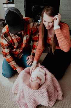 Mom and dad looking at newborn baby girl