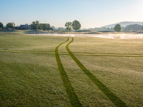 Cart tracks through morning dew on Robert Trent Jones Golf Trail