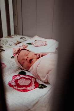 Newborn baby girl sleeping in crib