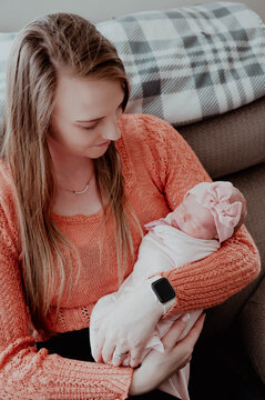 Young mother holding newborn baby girl