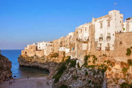 View of Lama Monachile in the rays of the setting sun, Polignano a Mare, Bari, Puglia, Italy