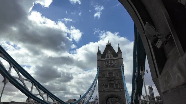 London tower bridge rising over the river thames with moving clouds in the financial district, an iconic landmark representing the uk's economy and business capital