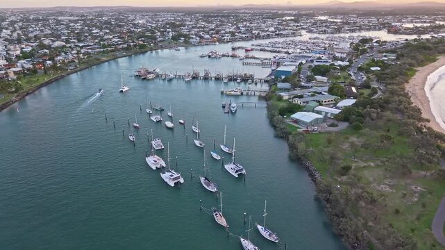 Aerial sunset over Mooloolaba Harbour marina and river channels, Sunshine Coast Queensland
