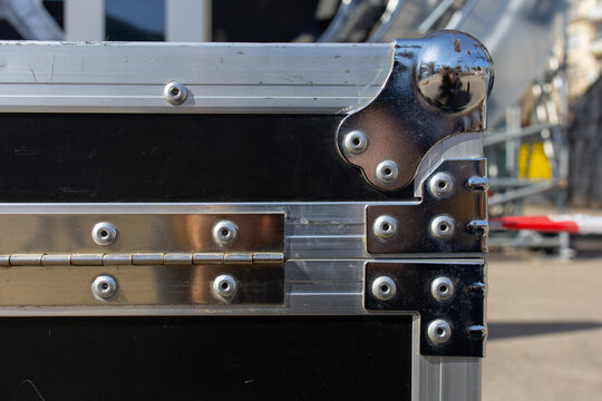 Reinforced corner of metal flight case with rivets, rugged equipment transport detail