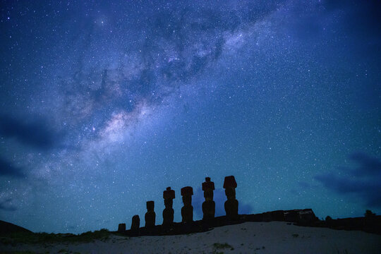 Peaceful majestic moai statue silhouette under starry night sky on easter island chile