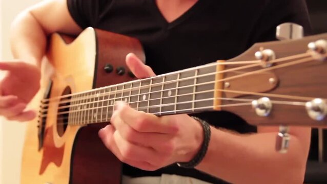 close up man playing guitar