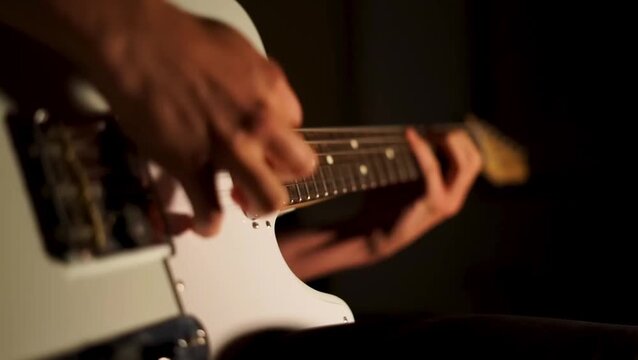 close up man playing guitar