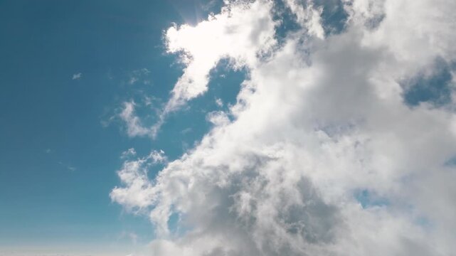Aerial views of the sunlight with clouds. Flying above the clouds
