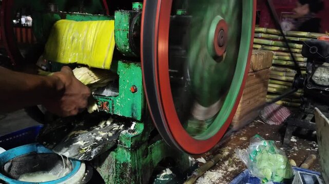 Traditional Mechanical Sugarcane Juice Extractor Machine in Operation