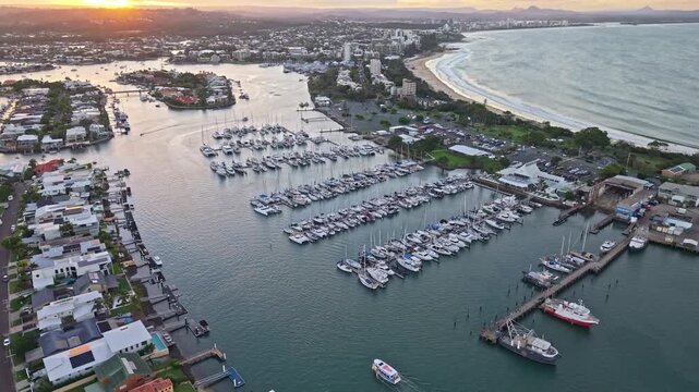Aerial sunset over Mooloolaba Harbour marina and river channels, Sunshine Coast Queensland