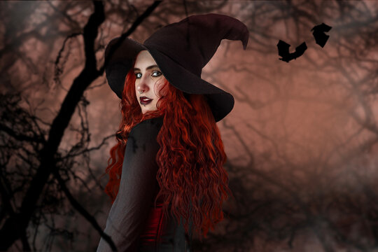 Witch with red hair looking over her shoulder. Young woman girl in Halloween clothes on isolated background.