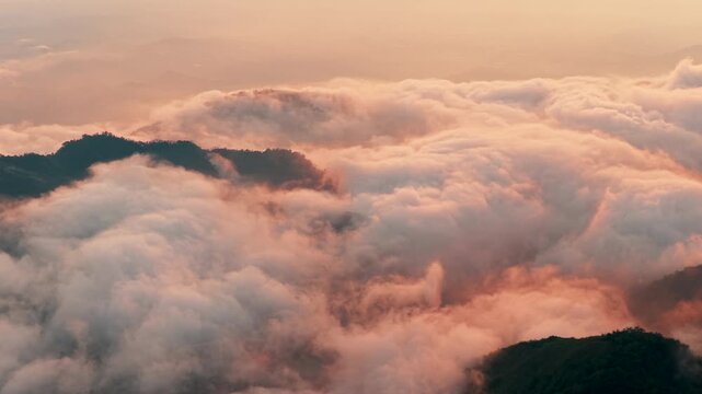 Aerial view above the sea of ​​clouds with the sunset