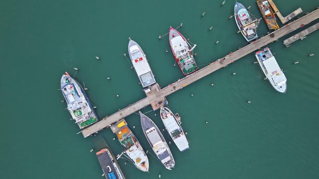 Top down aerial of fishing boats moored at Mooloolaba Harbour jetty, Sunshine Coast Queensland