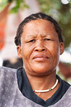 Portrait of Basarwa San old woman, outdoors in the bush in the Kalahari Desert