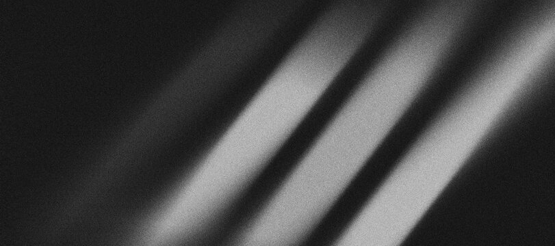 pattern of grayish-white gradient lines that divides metallic black background with a "grainy" texture.