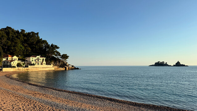 Petrovac beach at golden hour with calm Adriatic water and coastal villas