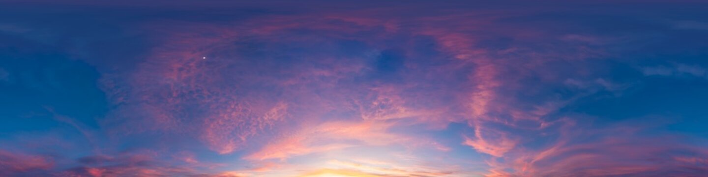 Sunset sky clouds panorama of colorful twilight sky with pink and purple clouds during a vibrant sunset over the horizon