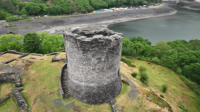 Cinematic Drone View of Dolbadarn Castle Tower Above Llyn Peris Lake in Snowdonia Wales