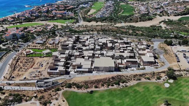 4K top-down drone flying over Anima Mall in Cabo San Lucas, showing the commercial center and surrounding area from above.
