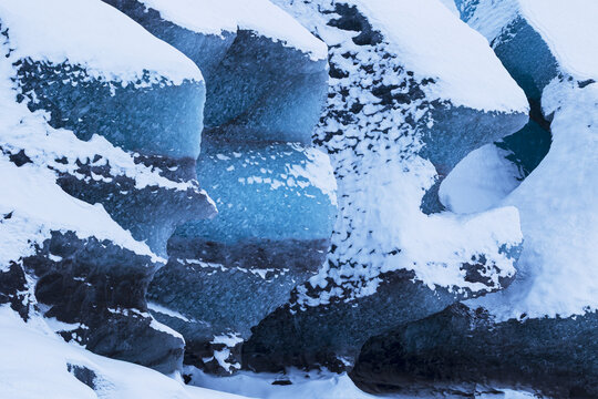 View of the deep blue ice formations and snow-covered ridges of the Svinafellsjokull glacier Sveitarfelagid Hornaf, Iceland.