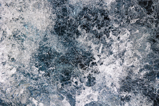 View of the intricate blue ice textures and crystalline structures of the Svinafellsjokull glacier in Sveitarfelagid Hornafjordur, Iceland.