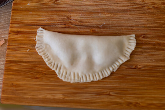 Cooking. Cooking chebureks. Raw meat in dough. A national dish. Cheburek - fried pie with meat and onions. 