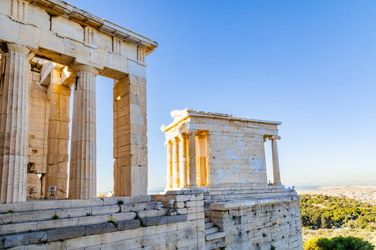 The Acropolis: the Temple of Athena Nike and the columns of the south wing of the Propylaea. Acropolis, Athens, Greece
