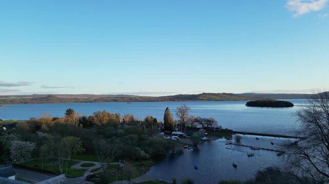 Aerial View of Calm Water of Massive Lake at Balmaha Valley Village Near Glasgow Landscape During Sunset. Village is a popular tourist destination for picnickers and day trippers from Glasgow