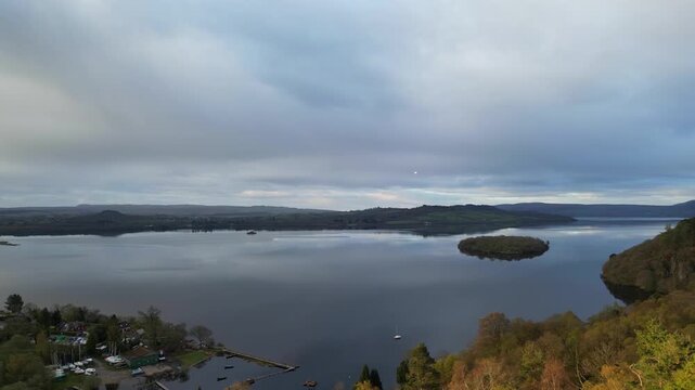 Aerial View of Calm Water of Massive Lake at Balmaha Valley Village Near Glasgow Landscape During Sunset. Village is a popular tourist destination for picnickers and day trippers from Glasgow