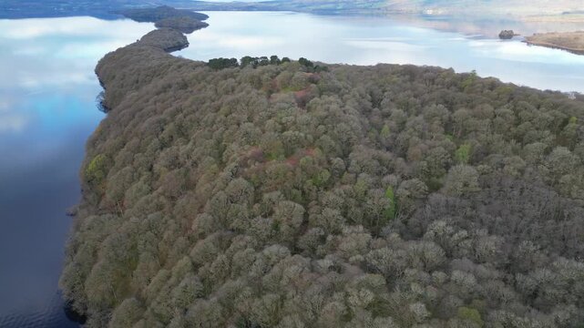 Aerial View of Calm Water of Massive Lake at Balmaha Valley Village Near Glasgow Landscape During Sunset. Village is a popular tourist destination for picnickers and day trippers from Glasgow