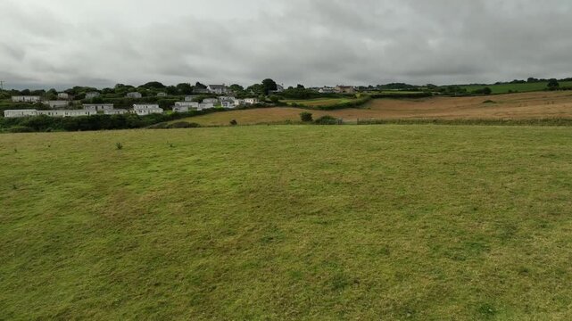 Aerial View of Green Pasture and Traditional Welsh Village on Anglesey Island North Wales