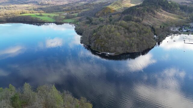 Aerial View of Calm Water of Massive Lake at Balmaha Valley Village Near Glasgow Landscape During Sunset. Village is a popular tourist destination for picnickers and day trippers from Glasgow