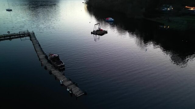 Aerial View of Calm Water of Massive Lake at Balmaha Valley Village Near Glasgow Landscape During Sunset. Village is a popular tourist destination for picnickers and day trippers from Glasgow