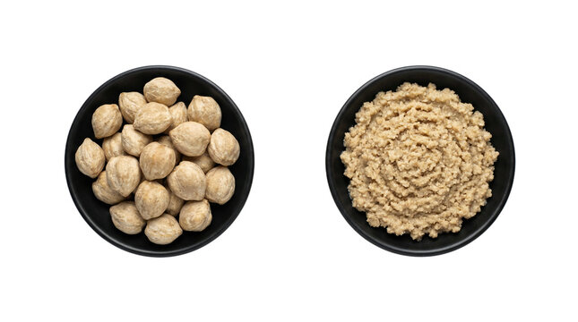 Isolated candlenuts and cooked bulgur wheat in black bowls on transparent background for healthy cuisine.