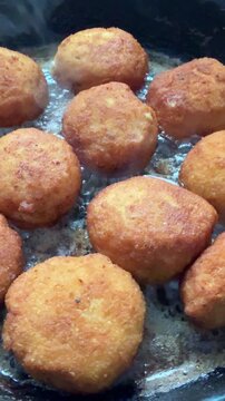 Fried cutlets in a frying pan, vertical video.