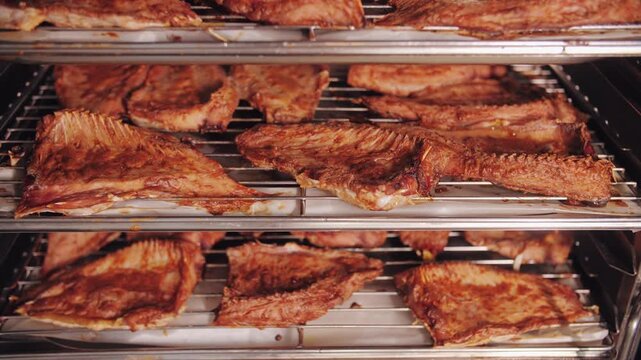 Commercial Smoked Fish Fillets on Stainless Racks.