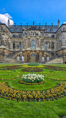 Fototapeta premium Baroque Palais in the Great Garden of Dresden with Spring Flowers and Blue Sky