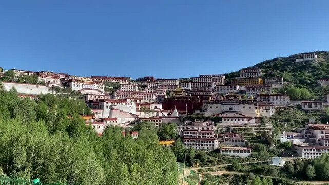 Panoramic view of Ganden Monastery rebuilt on hillside in Dagz&ecirc; Tibet, showcasing Tibetan Buddhist architecture, cultural heritage, and scenic Tibetan landscape.