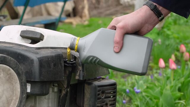 Filling a cultivator with motor oil and servicing garden equipment
