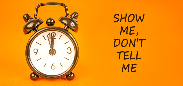 Tell or show symbol. Concept words Show me, do not tell me on beautiful orange paper. Beautiful orange paper background. Business tell or show concept. Copy space.