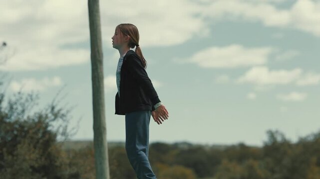 Young girl jumping on trampoline in slow motion