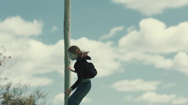 Young girl practicing slacklining outdoors on a sunny day